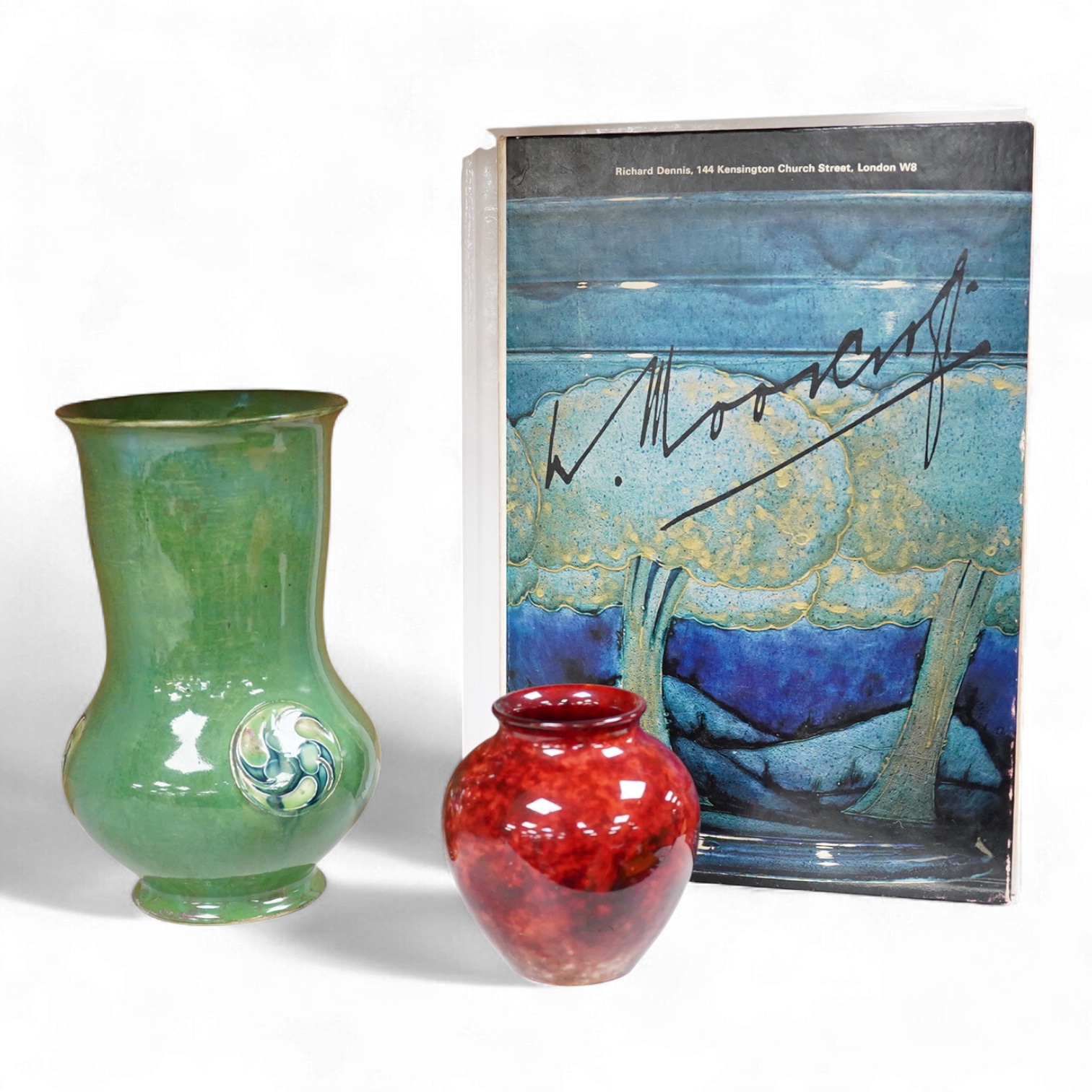 A Moorcroft for Liberty & Co. Flamminion Ware vase, and a smaller Moorcroft vase glazed in a mottled plum flambe, the first 20cm., also to include two Moorcroft reference books